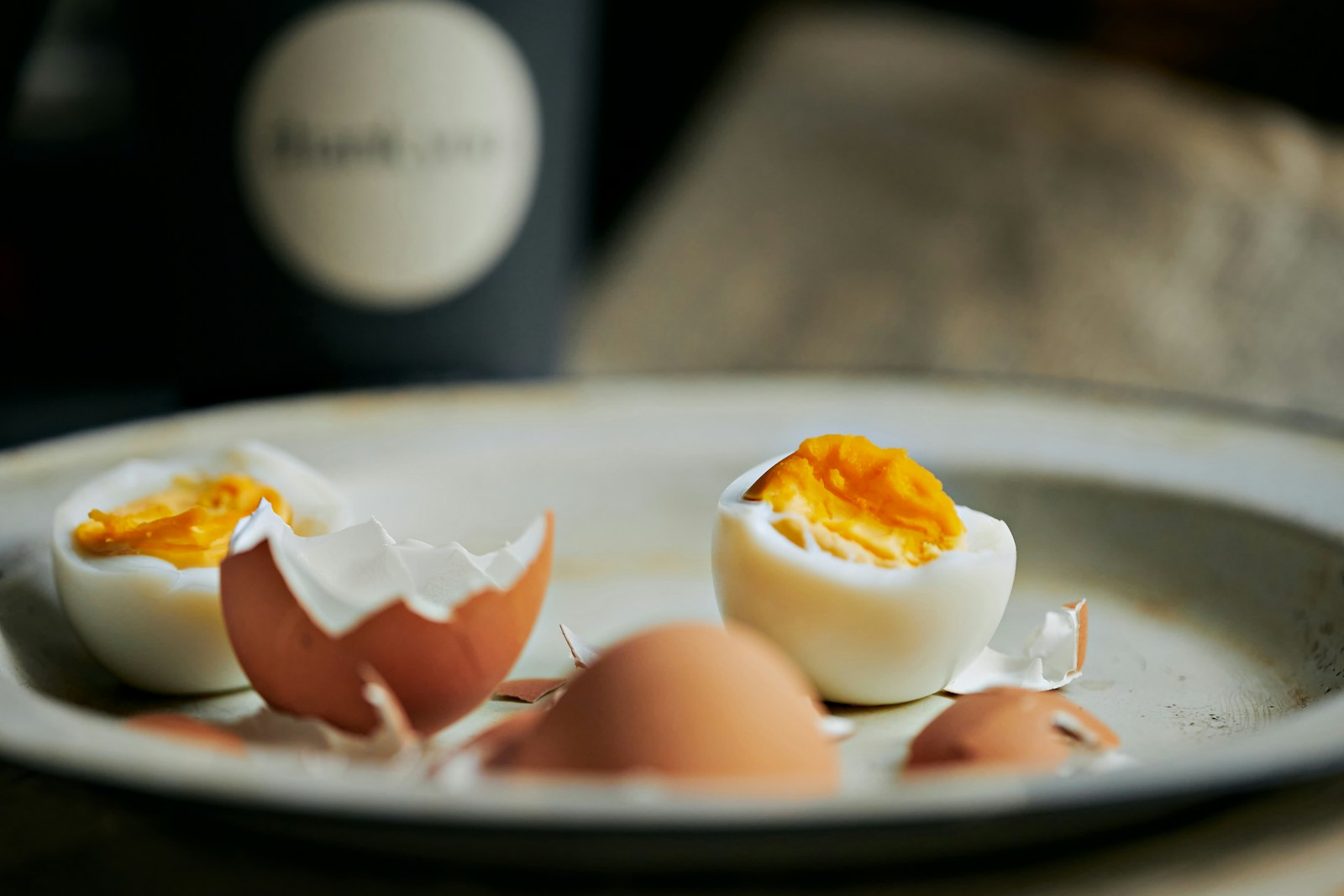 Halved boiled eggs and eggshells on a plate