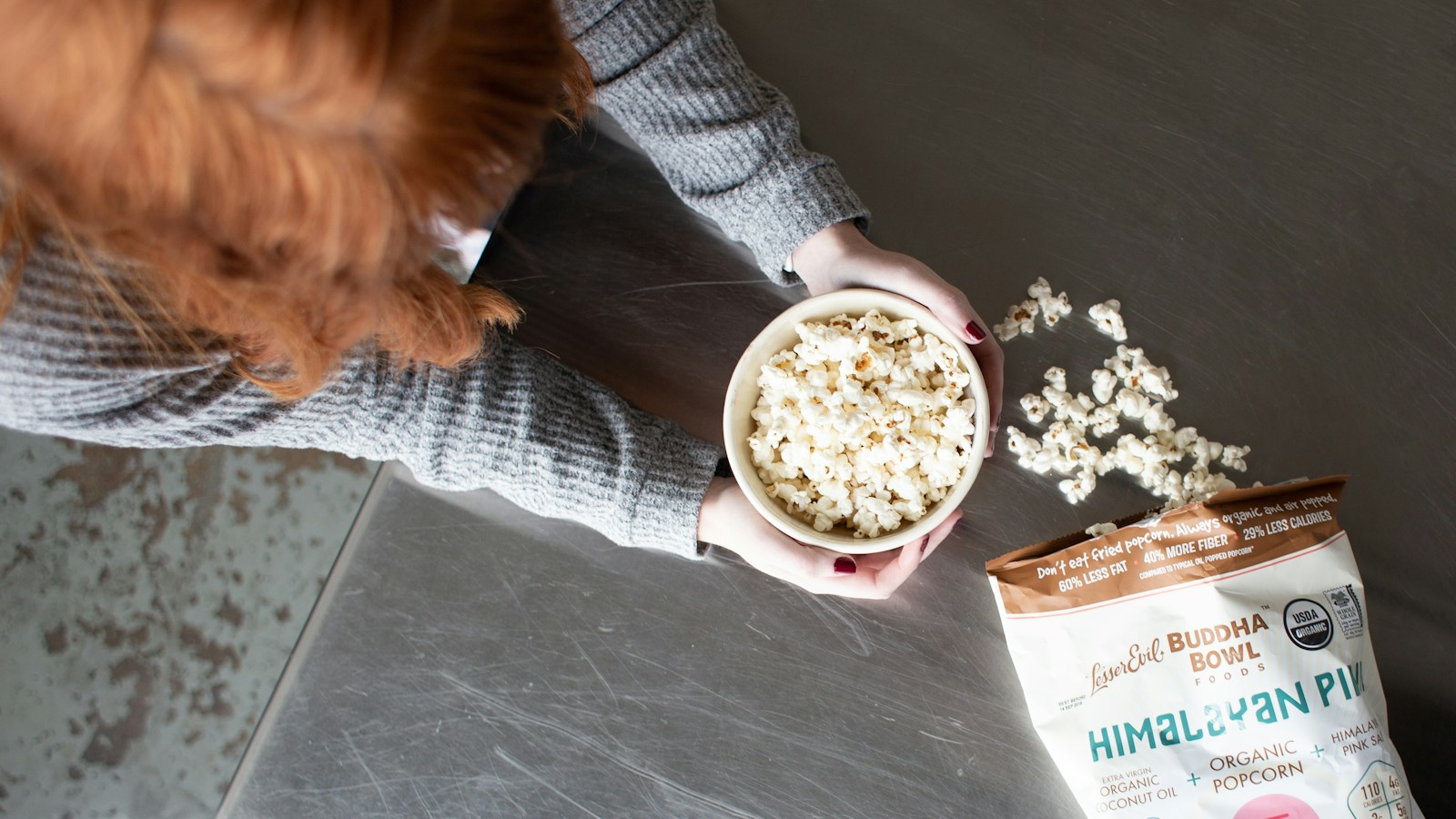 A person holding a bowl of popcorn