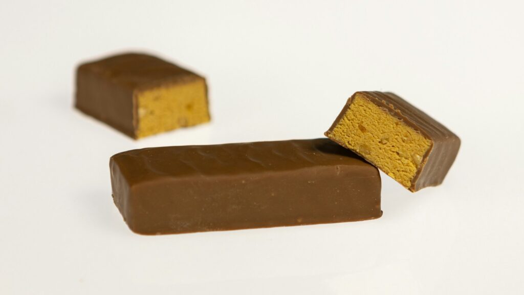 Chocolate-coated snack bars, with one cut to show the filling