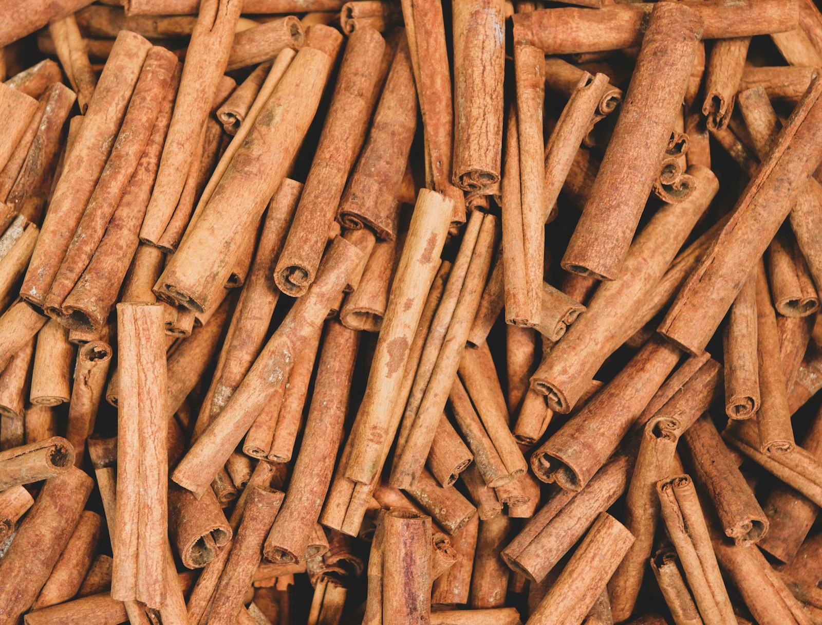 A collection of cinnamon sticks seen from above