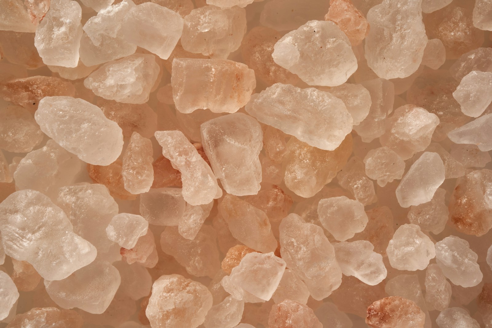 A close-up of coarse pink salt crystals