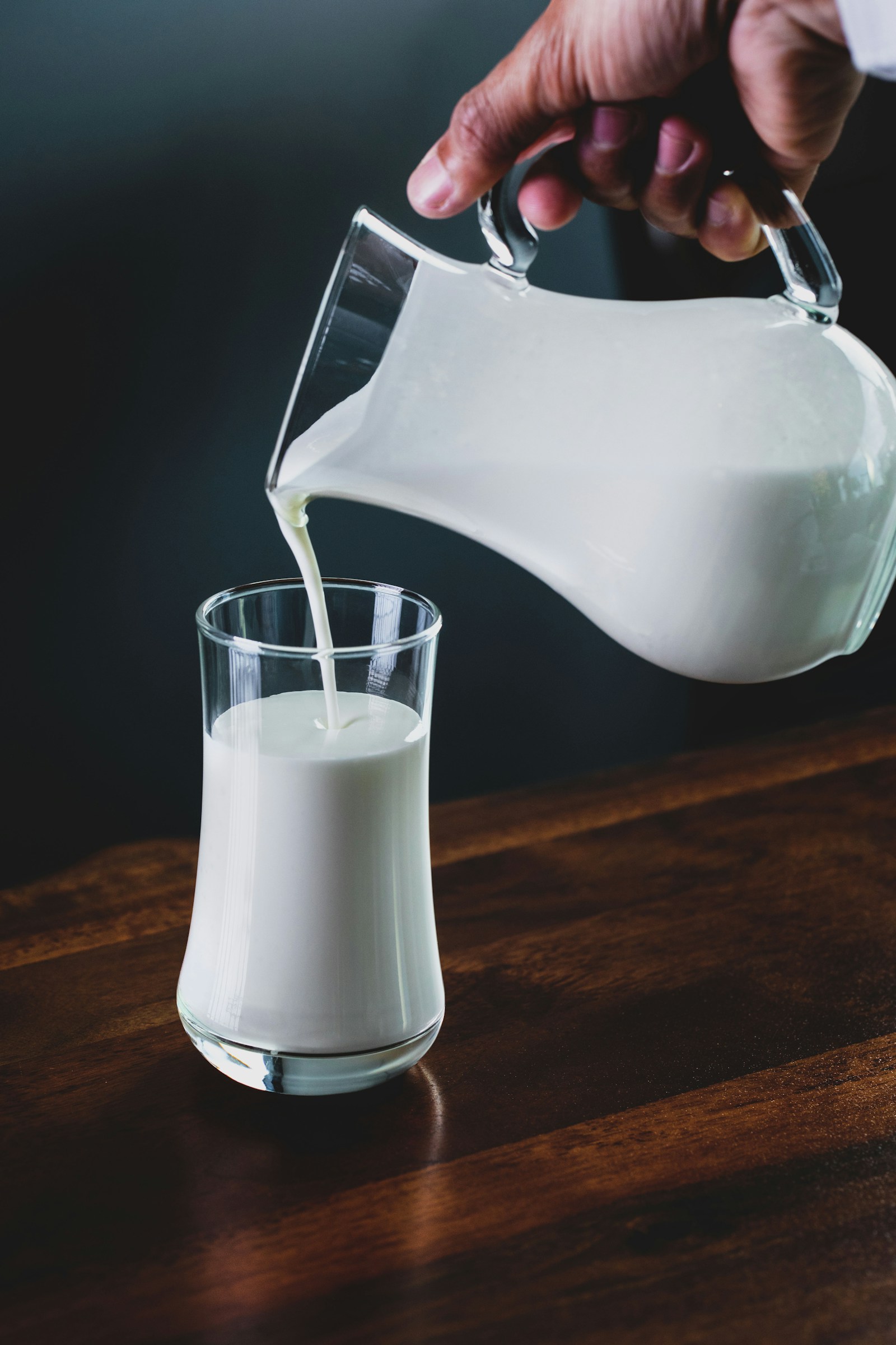 Cultured milk being poured from a glass jug