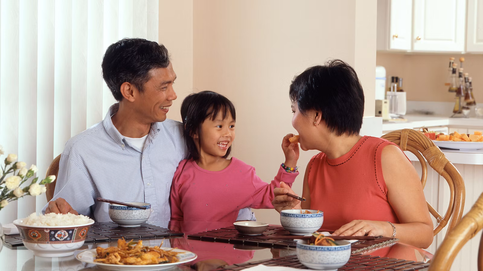 Family eating dinner together in a family weeknight meal plan
