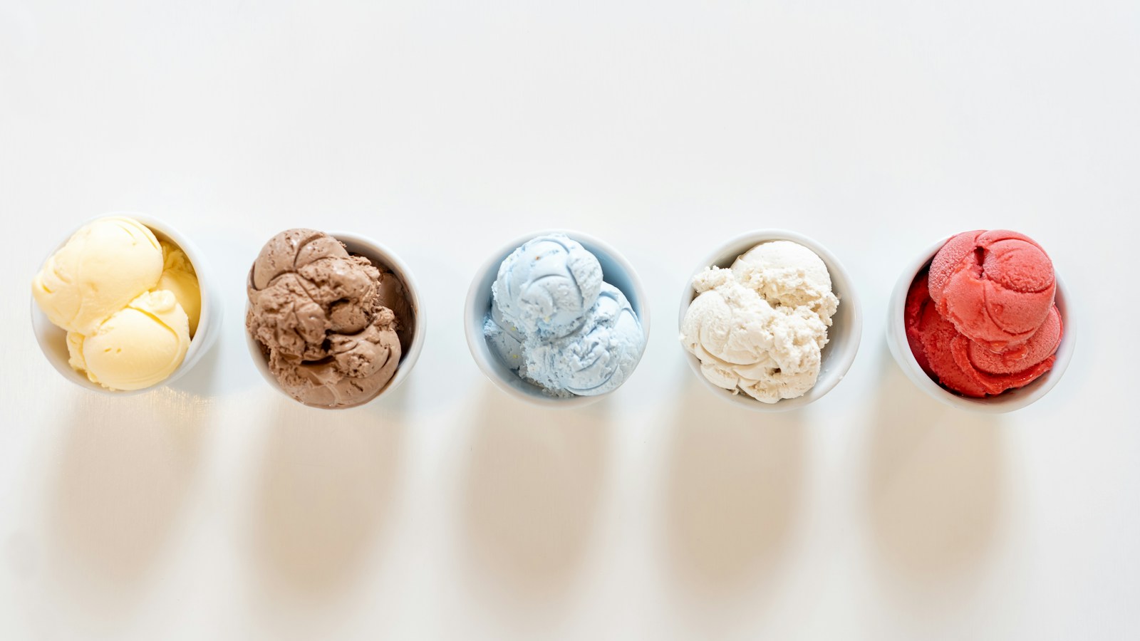 Five ice cream flavors served in small bowls