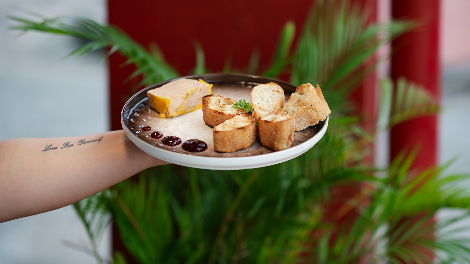 A plate of foie gras with bread and accompaniments