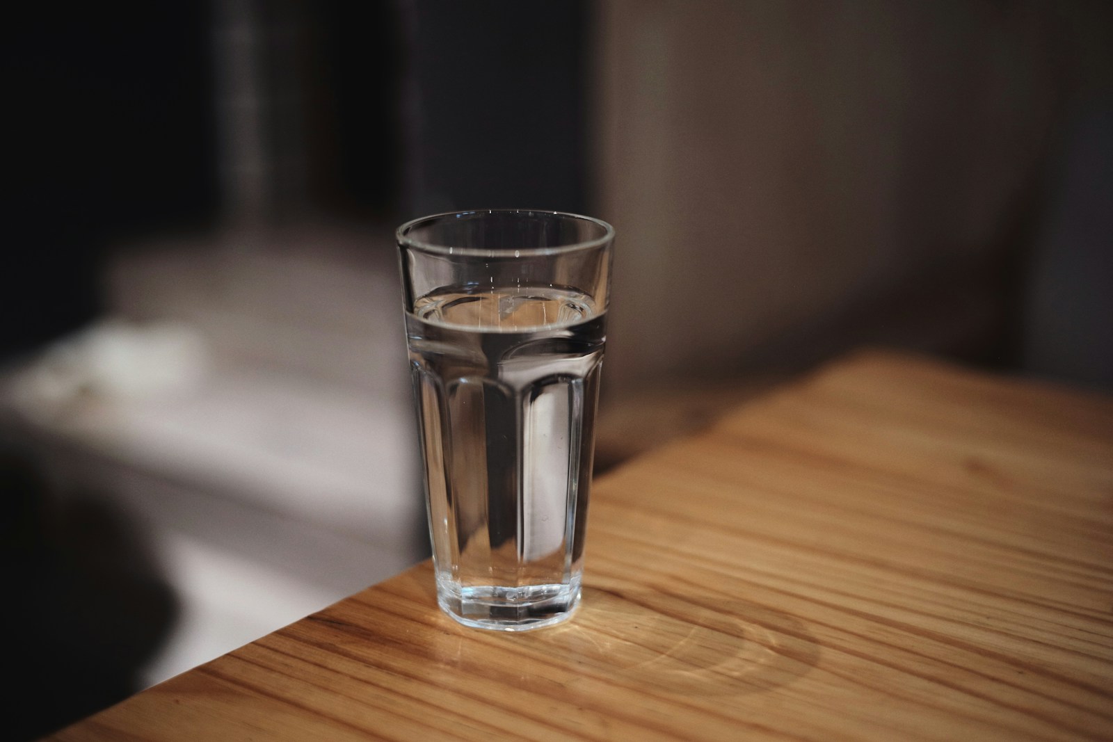 A clear glass of drinking water on a wooden table