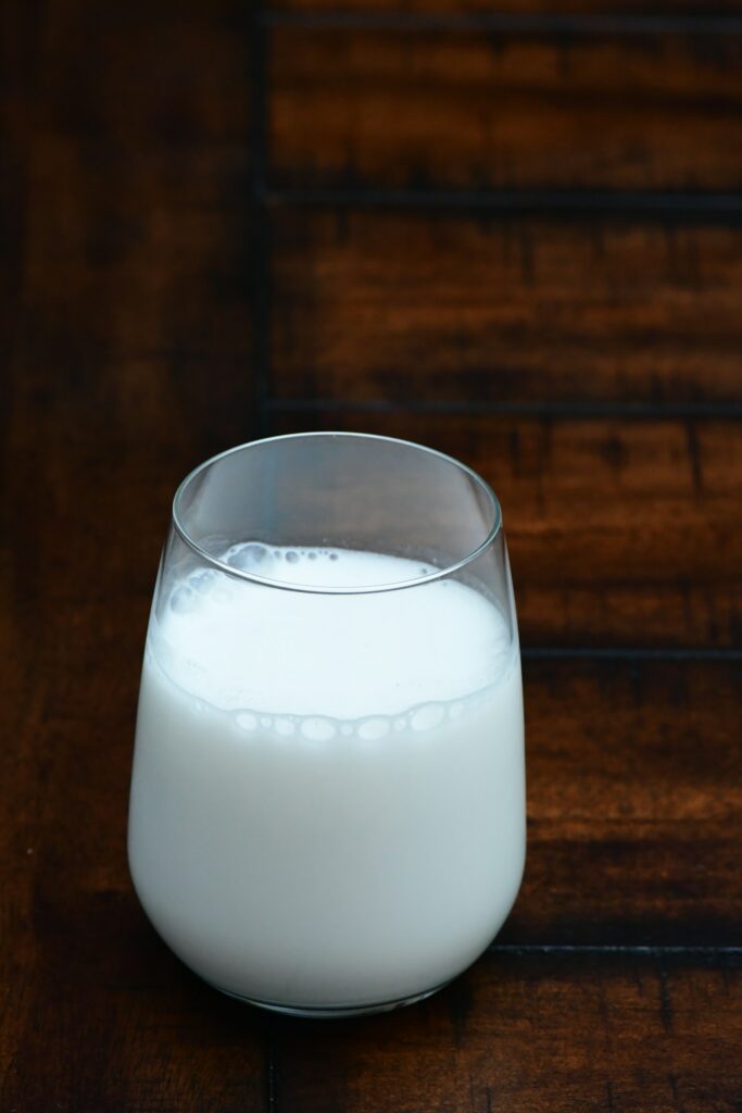 A glass of milk on a wooden table