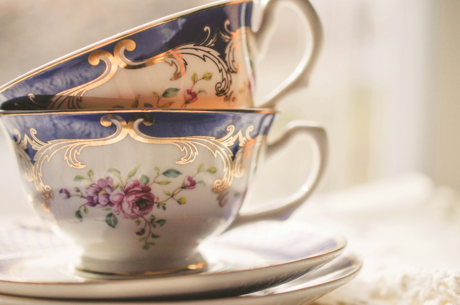 Two empty floral teacups stacked on saucers