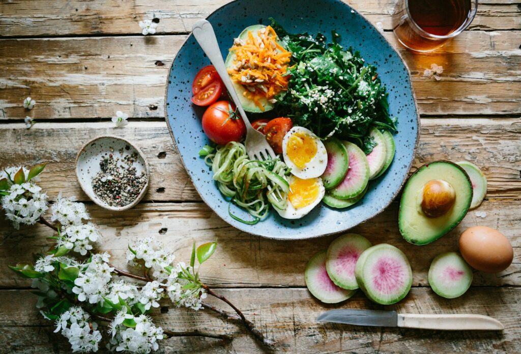 Vegetable bowl with egg, greens, and avocado