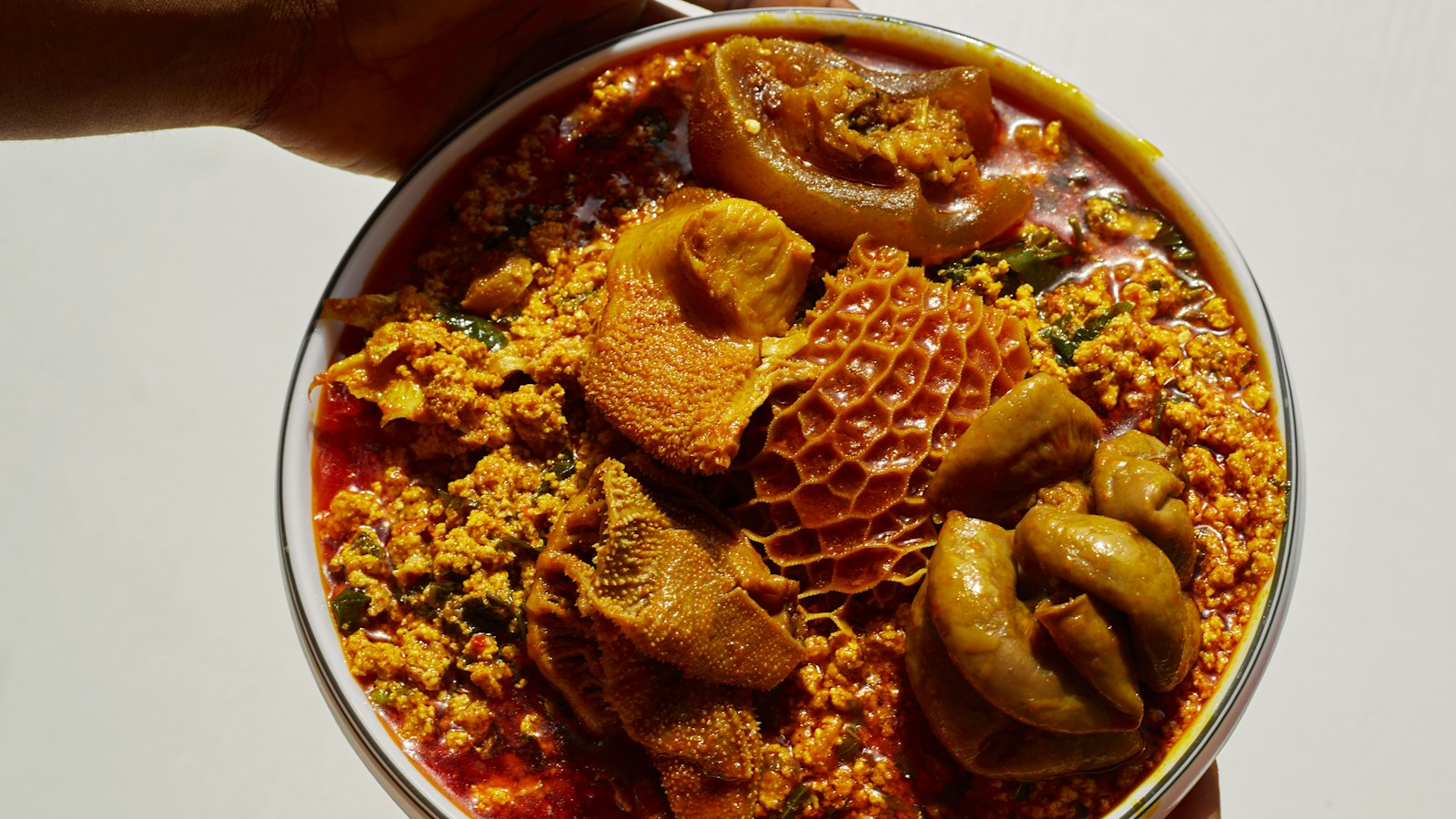 Honeycomb tripe and other pieces of meat in egusi soup