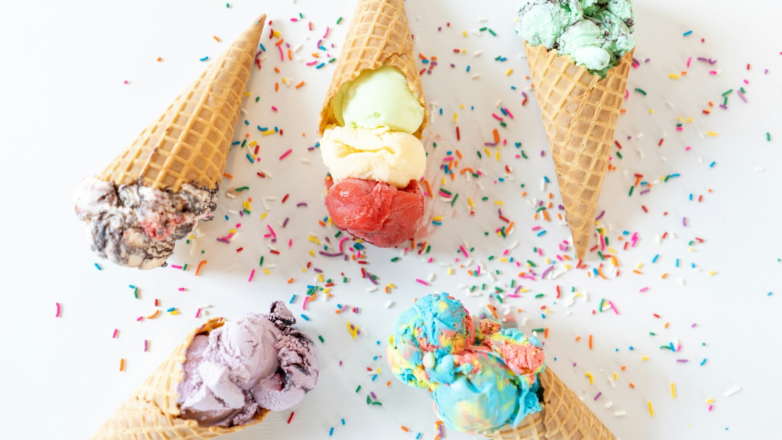 Ice cream scoops, cones, and colorful sprinkles