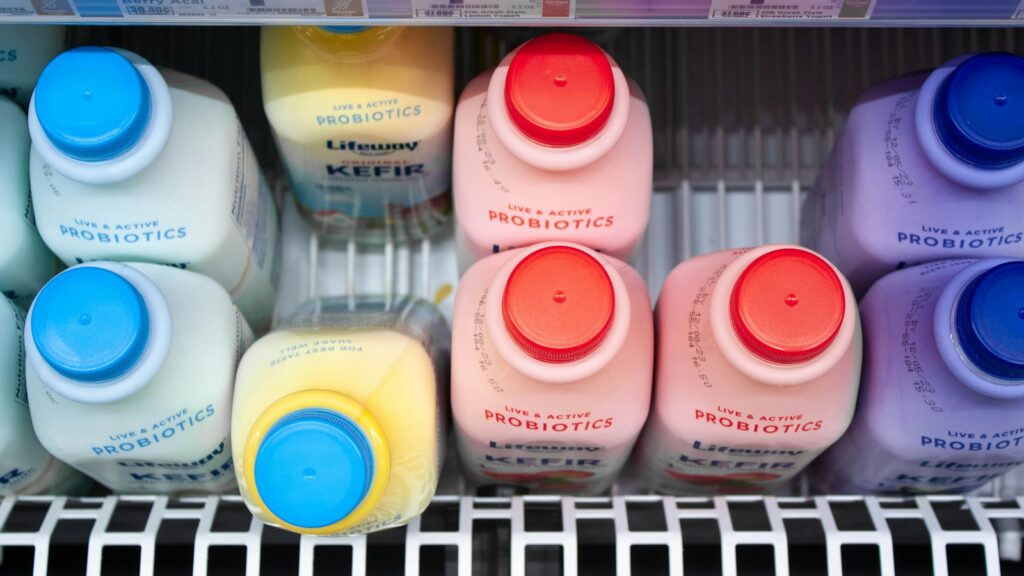 Bottles of kefir on a refrigerated store shelf