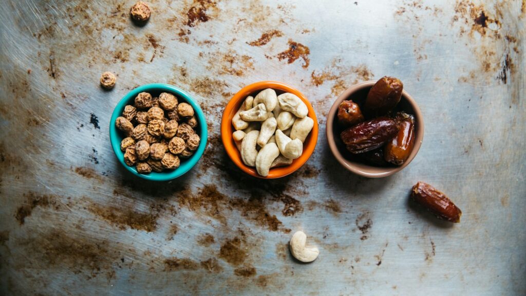 Small bowls of nuts and dried fruit on a table
