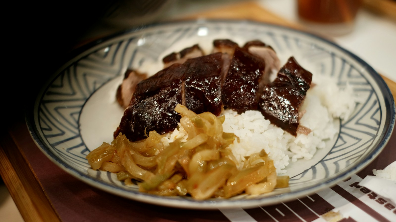 Sliced roast duck served with rice and pickled vegetables