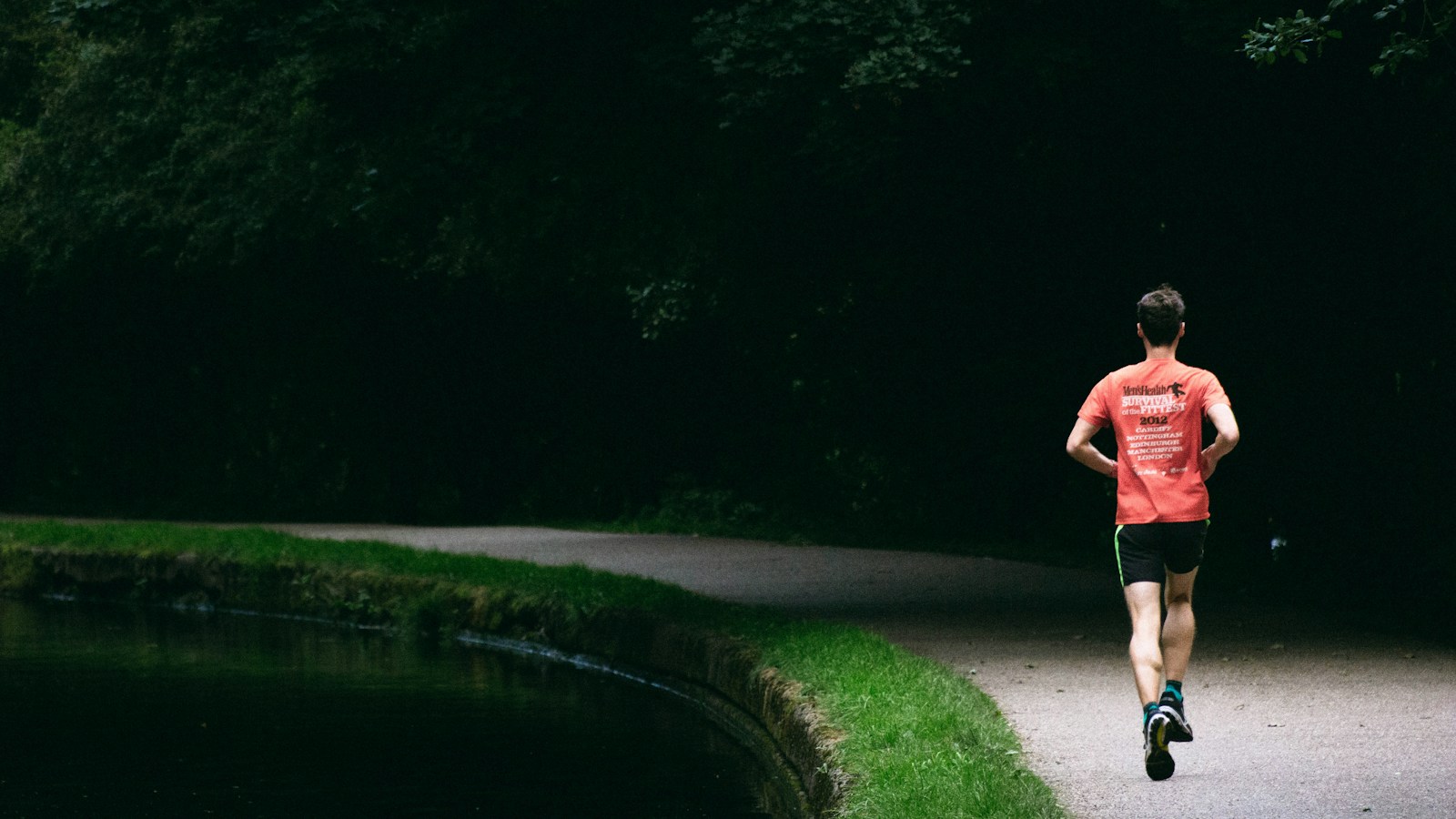 A runner on a path beside trees