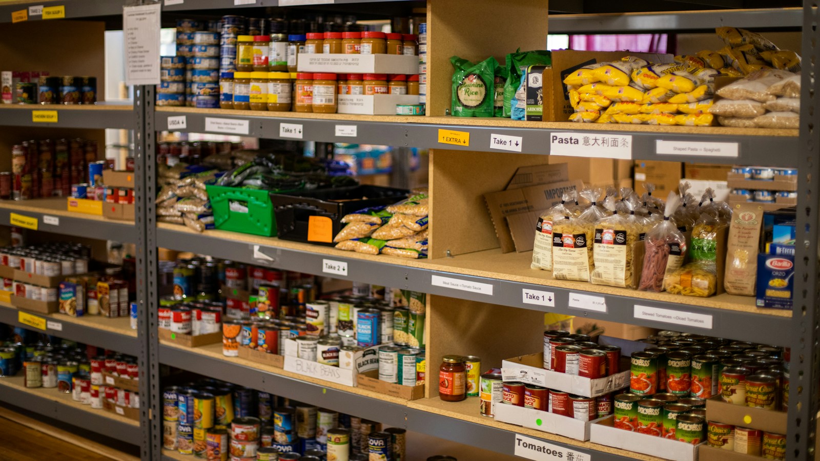 Shelves stocked with canned foods, pasta, and other pantry supplies