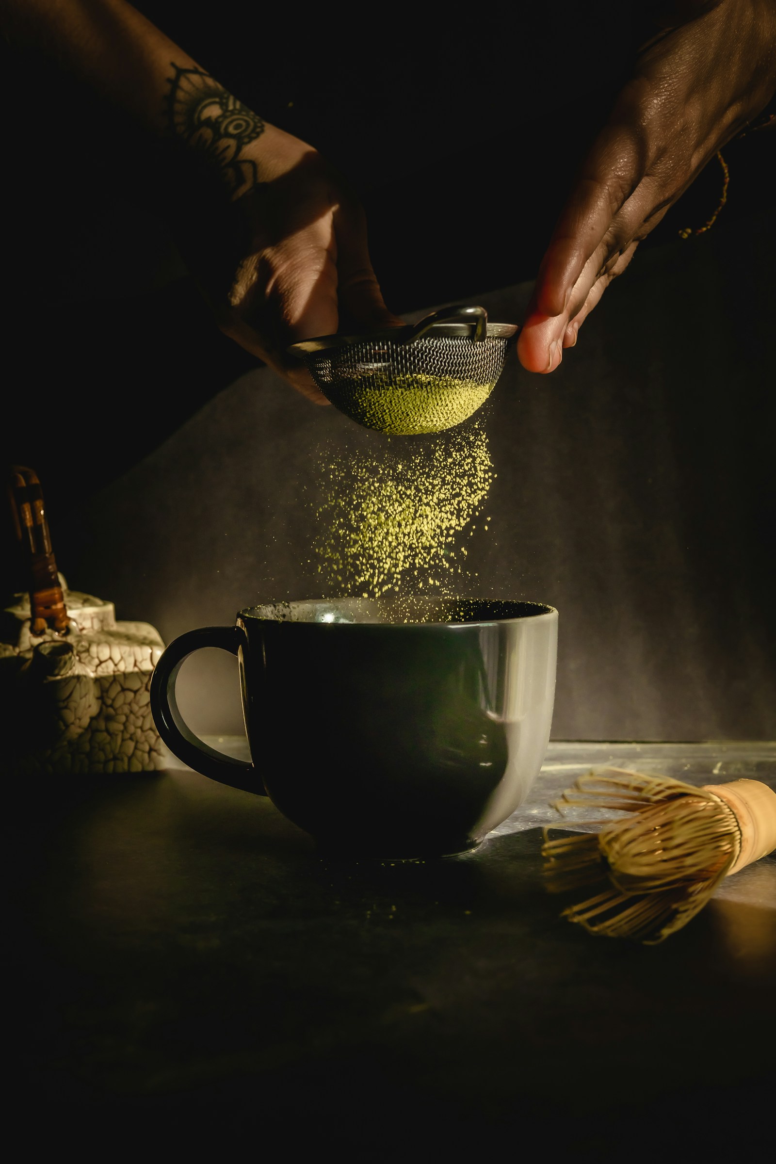 Matcha powder being sifted into a cup