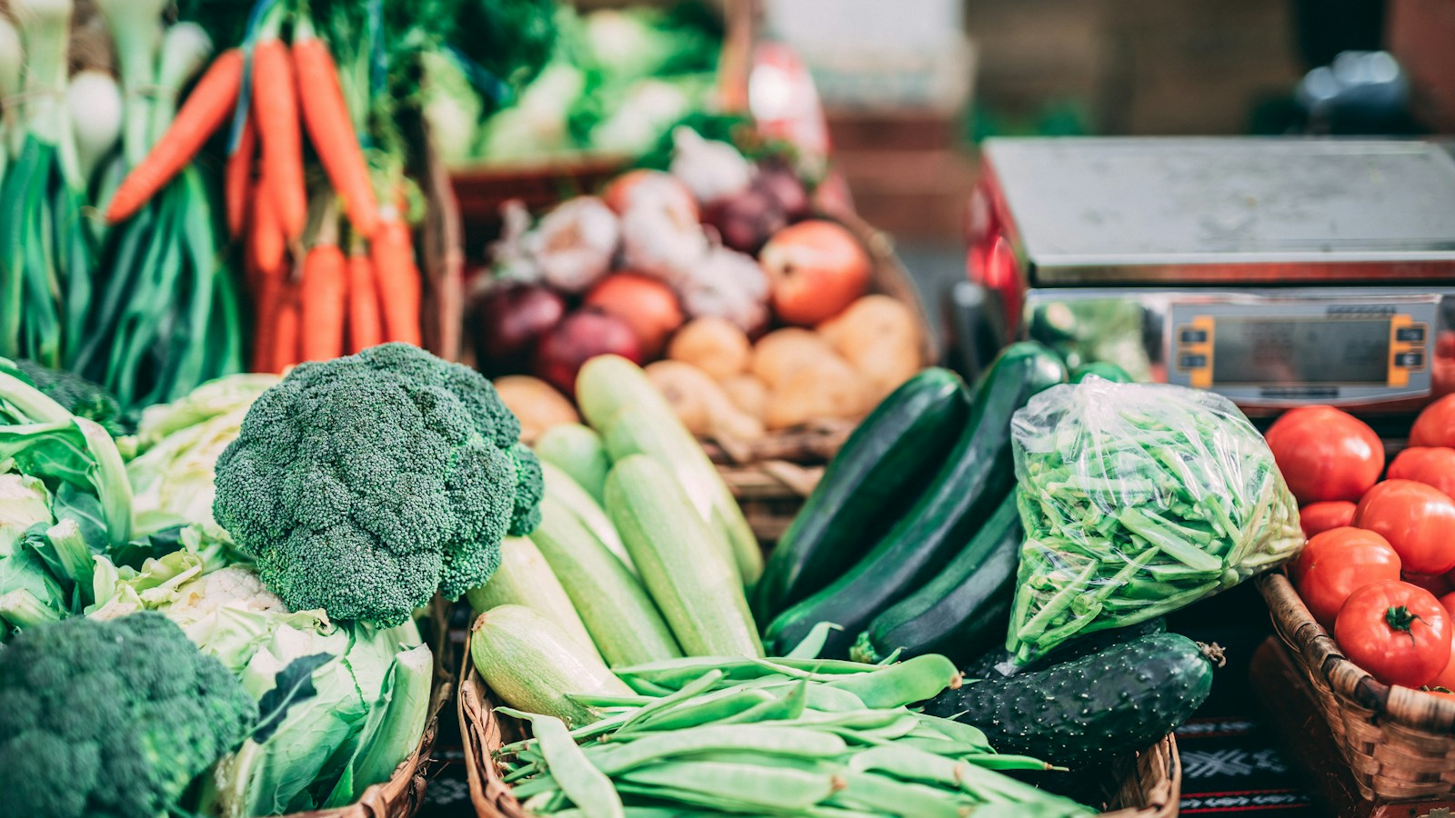 Carrots, broccoli, and other vegetables in market baskets